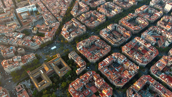 Barcelona city skyline, aerial view. Eixample residential district at sunrise. Catalonia, Spain. Cityscape with typical urban octagon blocks