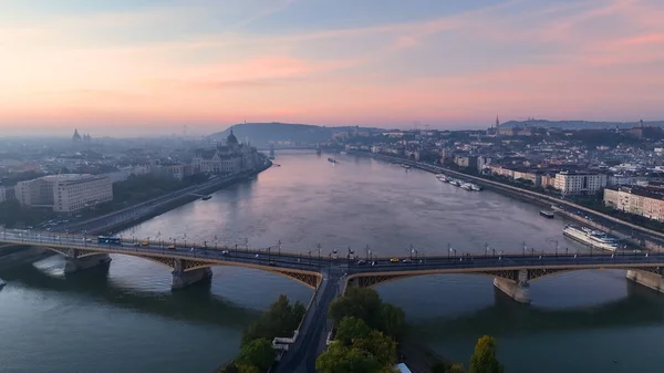 stock image Aerial view of Budapest Margaret Bridge or Margit hid over River Danube, embankment at sunrise. Public transport in the city