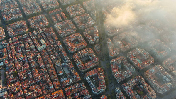 Barcelona City above the clouds and fog, typical buildings of Barcelona cityscape, Eixample residential famous urban grid, diagonal avenue, Spain