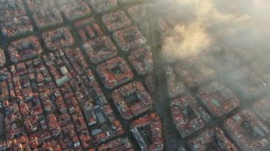 Bulutların ve sislerin üzerinde Barcelona Hava Aracı. Barselona şehir manzarasının tipik binaları. Eixample yerleşim bölgesi.