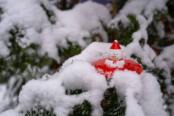 Bałwan Zabawka Czerwonym Kapeluszem Siedzi Śniegu Dekoracja Choinkowa Gałęzi Choinki — Zdjęcie stockowe
