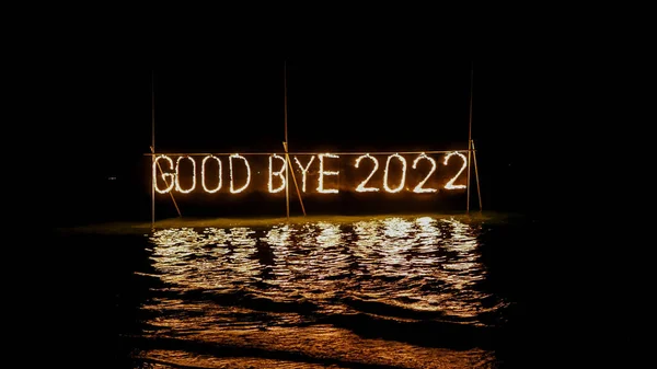 Good Bye 2022 Burning Phrase Made Fire Stick Placed Water — Stock Photo, Image
