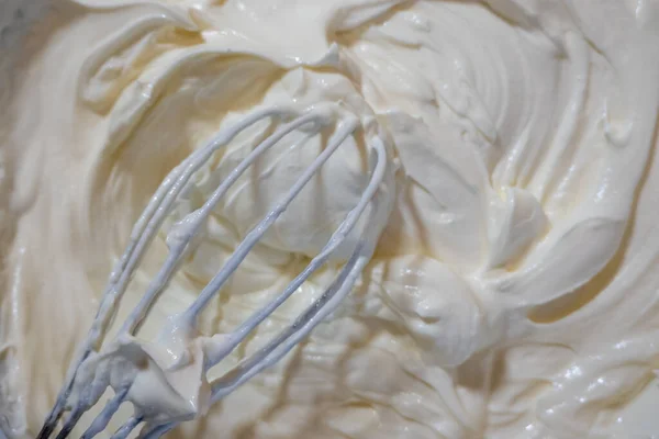 stock image close up of a bowl of cream with whisk, texture of mascarpone soft cream cheese, cooking process 