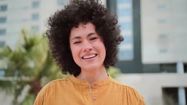 Front View Happy Young Hispanic Woman Smiling Tauching Her Curly — Wideo stockowe