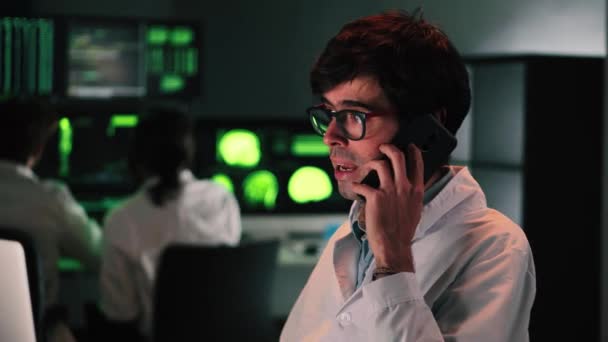 Serious Doctor Glasses Lab Coat Calling Cell Phone Patient Give — 图库视频影像