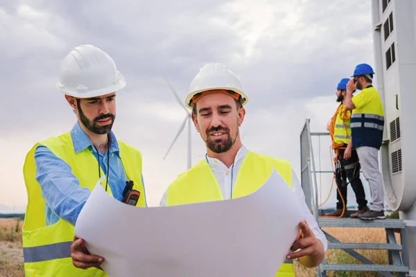 Two Windmill Engineers Looking Blueprint Plan Construction Electricy Turbine Background — Stock Photo, Image