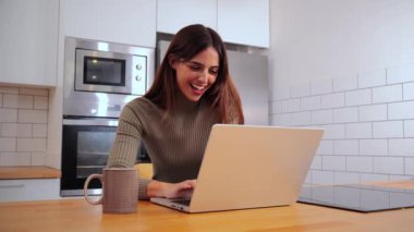 Genç girişimci kadın ev ofisinde dizüstü bilgisayarla çalışıyor. Mutfağında defteriyle gezen mutlu genç bir kız. İnternette gezinmek için bilgisayar kullanan esmer bir kadın.
