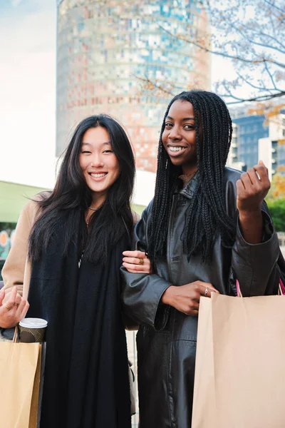 Two Happy Young Women Smiling Looking Camera Carrying Shopping Bags — Foto de Stock