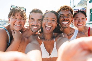 Bir grup neşeli arkadaş plajda unutulmaz bir anı yakalıyorlar. Kahkaha ve mutluluk dolu bir selfie ile. Sıcak güneş ışığı altında, birlikte unutulmaz anılar yaratıyorlar..