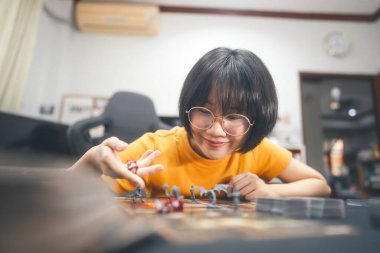 People lifestyle with interesting hobby at home concept. Young adult asian woman playing board game on top table. Happy with smile face.