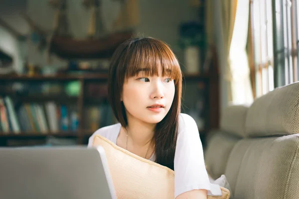 College student study online stay at home for social distancing and new normal concept. Portrait attractive cute asian teenager woman using laptop for internet education.