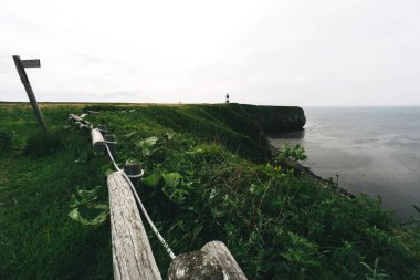 Notoro cape wide area meadow destination for activity on summer. Lighthouse landmark see okhotsk ocean at Abashiri city, Hokkaido, Japan.