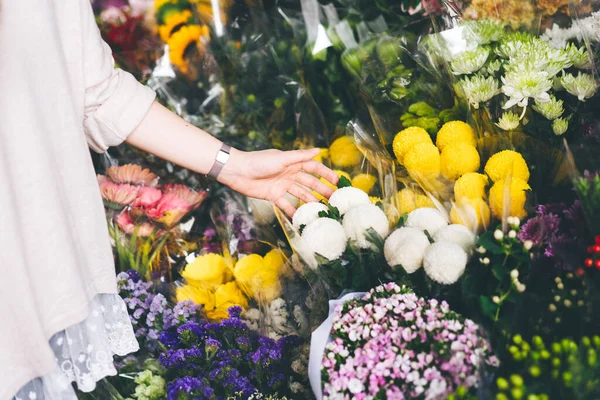 Asian woman buy a flower bouquet at floral shop.