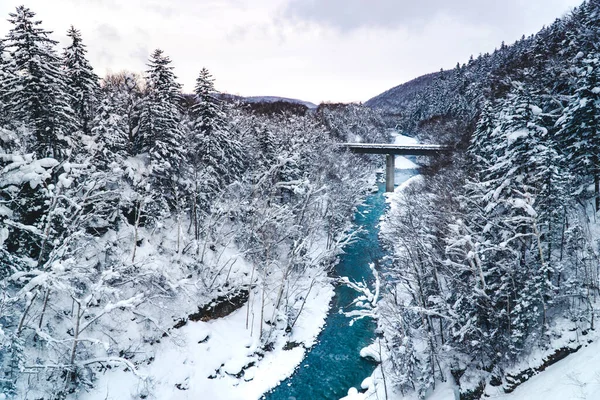 Biei blue river screen on winter. Bridge among white forest in morning. Hokkaido, Japan.