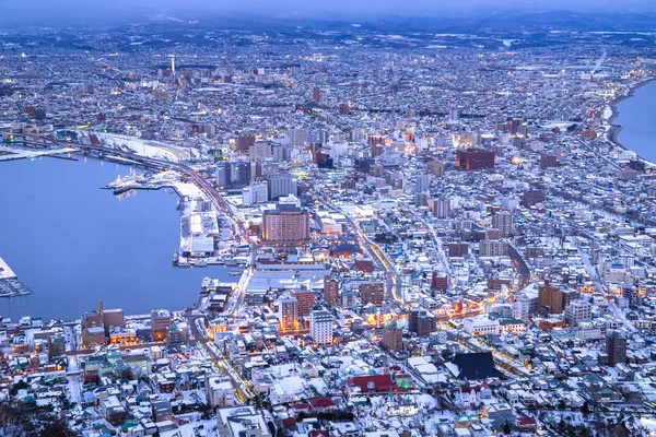 stock image Hakodate bay cityscape dramatic scene on winter view from observation point up on mountain. Famous destination panorama of town and sea. Skylight before sunset. Hokkaido, Japan.