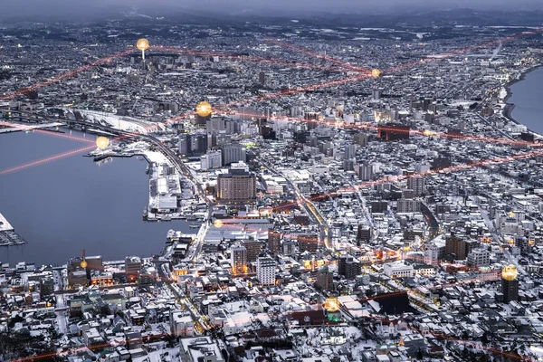 Social network connection concept. Hakodate bay cityscape dramatic scene on winter view from observation point up on mountain. Hokkaido, Japan.