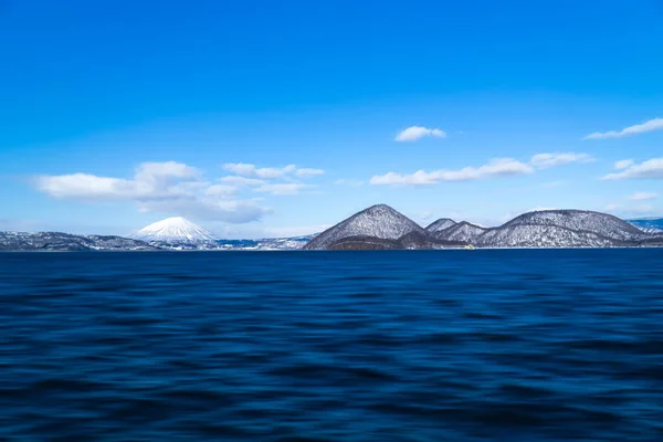 Toya lake with daylight view at Toyako town. Yotei mountain on background. Hokkaido, Japan.