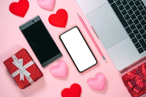 Dating app couple via internet online concept. Two smart phone with red heart blank screen for mock up or copy space. Valentine day pink theme color background.