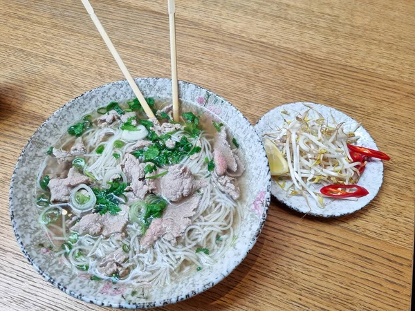 Pho Vietnamese Noodle Soup Beef Chopsticks Hand High Quality Photo — Stock Photo, Image
