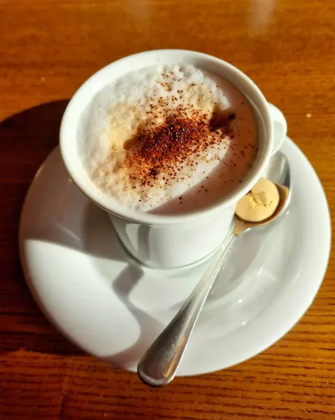 Cup of coffee cappuccino with foam oil and biscuit. High quality photo