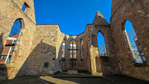 The ruined church showcases a blend of architectural engineering with an ancient archway, set against an electric blue sky as a backdrop Hanover Germany
