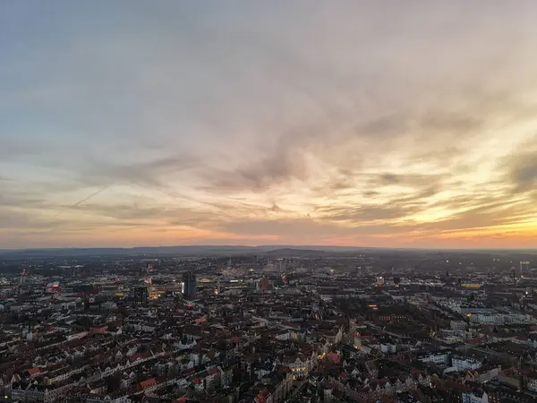 Gün batımında nefes kesici ve büyüleyici bir şehir manzarası. Gökyüzündeki canlı şehir yaşamını ve renkli renkleri gözler önüne seriyor. Hannover Listesi Düşük Saksonya