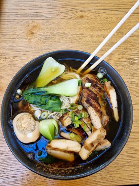 Izgara tavuk, taze sebze, erişte ve zengin aromatik et suyuyla lezzetli bir ramen kasesinin tadını çıkarın.