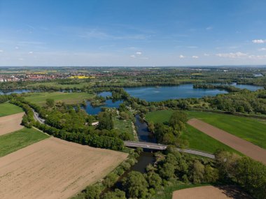 Parlak mavi göller ve açık gökyüzünün altında yemyeşil alanlar bulunan nefes kesici bir hava manzarası. Hannover Pattensen 'i gördüm.