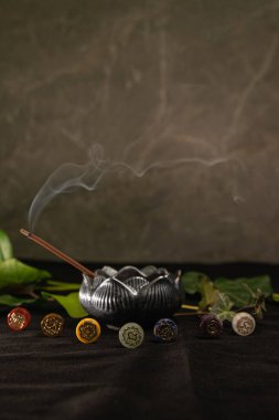 Exploring the harmony of chakras through incense and vibrant symbols