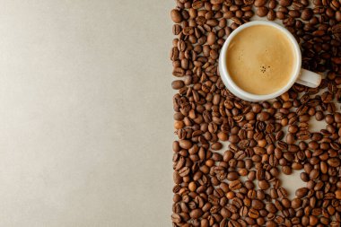 Sıcak kahve fincanı güzel kokulu fasulyelerin arasında samimi anlara davetiye çıkarıyor.