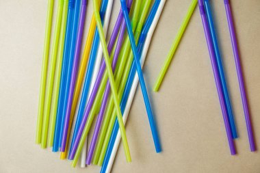 Bej bir yüzeye saçılmış renkli pipetler yaratıcılığa ilham verir.