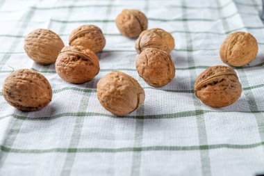 Güzel beyaz bir havluya izole edilmiş taze cevizler. Menü için arka plan. Metin için boşluk