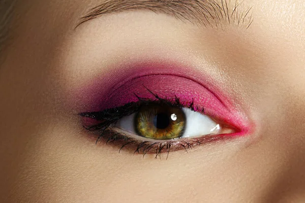 Closeup Macro of Woman Face with Green Eyes Make-up. Fashion Pink Celebrate Makeup, Glowy Clean Skin, perfect Shapes of Brows. Shiny Simmer