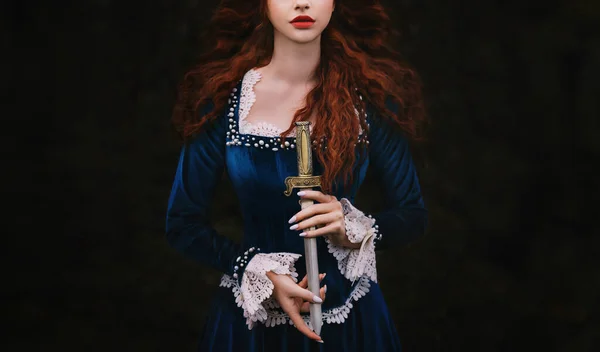 Fantasy woman warrior on black background, lady with red lips, long hair hands close up holding dagger, knife short sword. Girl gothic princess witch. Vintage blue dress old style. Art cropped face.