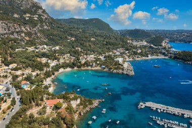 Picturesque seaside of Paleokastritsa, Corfu, Greece. Beautiful bay in Paleokastritsa in Corfu island, Greece. Panoramic view of Palaiokastritsa, boats and beach Corfu, Greece