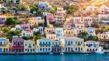 View of the beautiful greek island of Symi (Simi) with colourful houses and small boats. Greece, Symi island, view of the town of Symi (near Rhodes), Dodecanese.