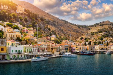 View of the beautiful greek island of Symi (Simi) with colourful houses and small boats. Greece, Symi island, view of the town of Symi (near Rhodes), Dodecanese.
