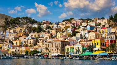 View of the beautiful greek island of Symi (Simi) with colourful houses and small boats. Greece, Symi island, view of the town of Symi (near Rhodes), Dodecanese.