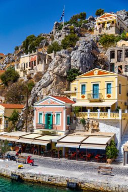 View of the beautiful greek island of Symi (Simi) with colourful houses and small boats. Greece, Symi island, view of the town of Symi (near Rhodes), Dodecanese.