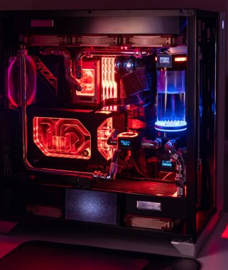 Prague, Czech Republic - 21 July 2021: Close-up of high performance Desktop PC and water cooling system with multicolored LED RGB light show status on working, interior on Computer PC Case and DIY