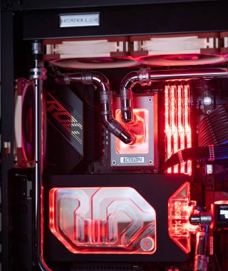 Prague, Czech Republic - 21 July 2021: Close-up of high performance Desktop PC and water cooling system with multicolored LED RGB light show status on working, interior on Computer PC Case and DIY