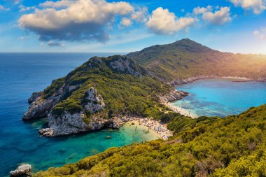 Porto Timoni is an amazing beautiful double beach in Corfu, Greece. Porto Timoni beach at Afionas is a paradise double beach with crystal clear azure water in Corfu, Ionian island, Greece, Europe