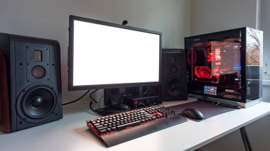 Powerful personal computer gamer rig with white screen. Professsional gaming empty room studio with neon lights and RGB powerful computer, keyboard and mouse. White screen on pc display.