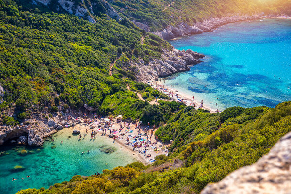 Porto Timoni is an amazing beautiful double beach in Corfu, Greece. Porto Timoni beach at Afionas is a paradise double beach with crystal clear azure water in Corfu, Ionian island, Greece, Europe