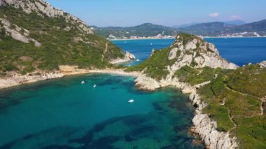 Porto Timoni is an amazing beautiful double beach in Corfu, Greece. Porto Timoni beach at Afionas is a paradise double beach with crystal clear azure water in Corfu, Ionian island, Greece, Europe