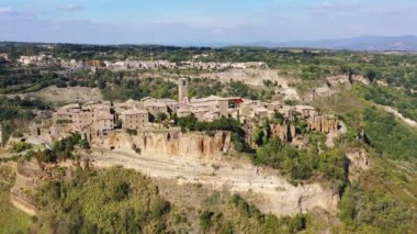 The famous Civita di Bagnoregio on a sunny day. Province of Viterbo, Lazio, Italy. Medieval town on the mountain, Civita di Bagnoregio, popular touristic stop at Tuscany, Italy.