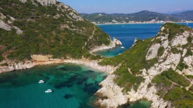 Porto Timoni is an amazing beautiful double beach in Corfu, Greece. Porto Timoni beach at Afionas is a paradise double beach with crystal clear azure water in Corfu, Ionian island, Greece, Europe