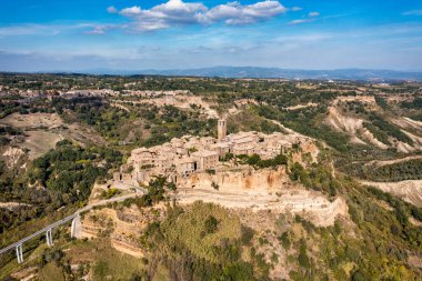 The famous Civita di Bagnoregio on a sunny day. Province of Viterbo, Lazio, Italy. Medieval town on the mountain, Civita di Bagnoregio, popular touristic stop at Tuscany, Italy.