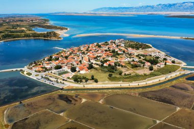 Historic town of Nin laguna aerial view with Velebit mountain background, Dalmatia region of Croatia. Aerial view of the famous Nin lagoon and medieval in Croatia