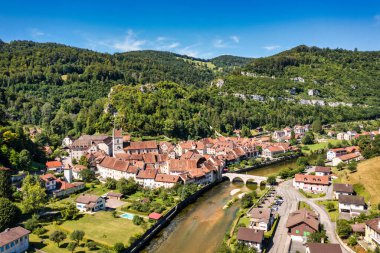 Picturesque Swiss village of Saint-Ursanne on the Doubs River, Switzerland. Village Saint-Ursanne in the district of Porrentruy in the canton of Jura, Switzerland. Saint Ursanne, Jura, Suisse clipart